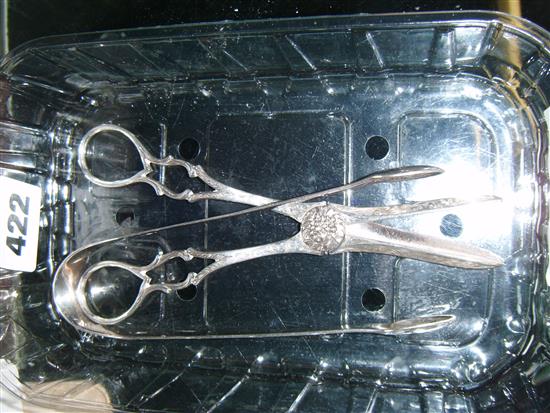 A pair of George III silver sugar tongs and a pair of Victorian silver grape shears